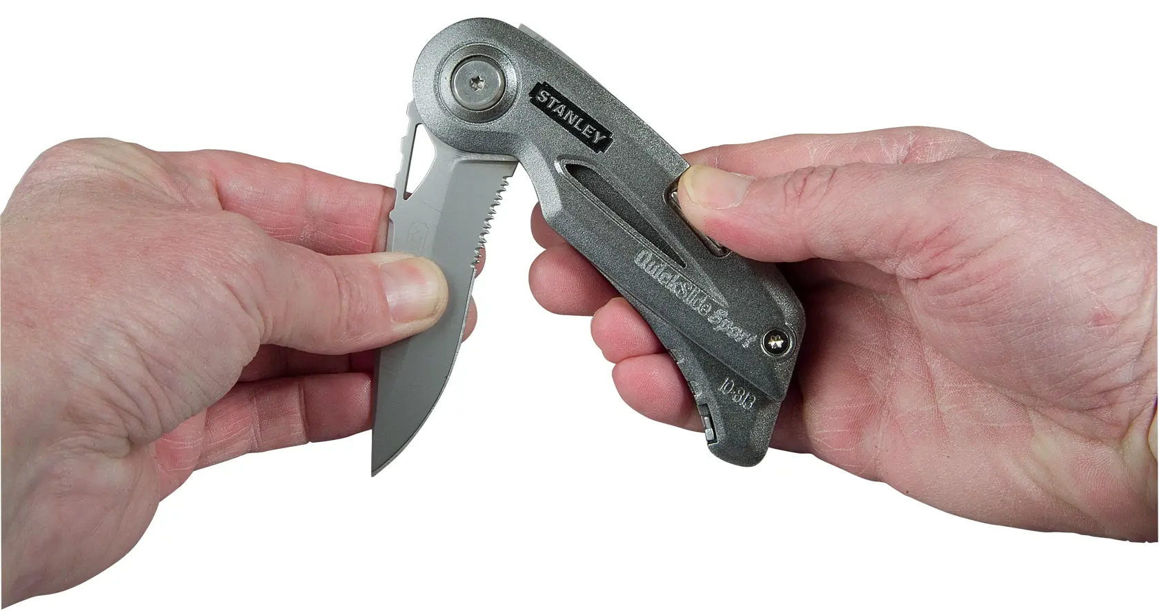 Photo of STANLEY 0-10-813 folding utility knife being opened with two hands, silver finish.