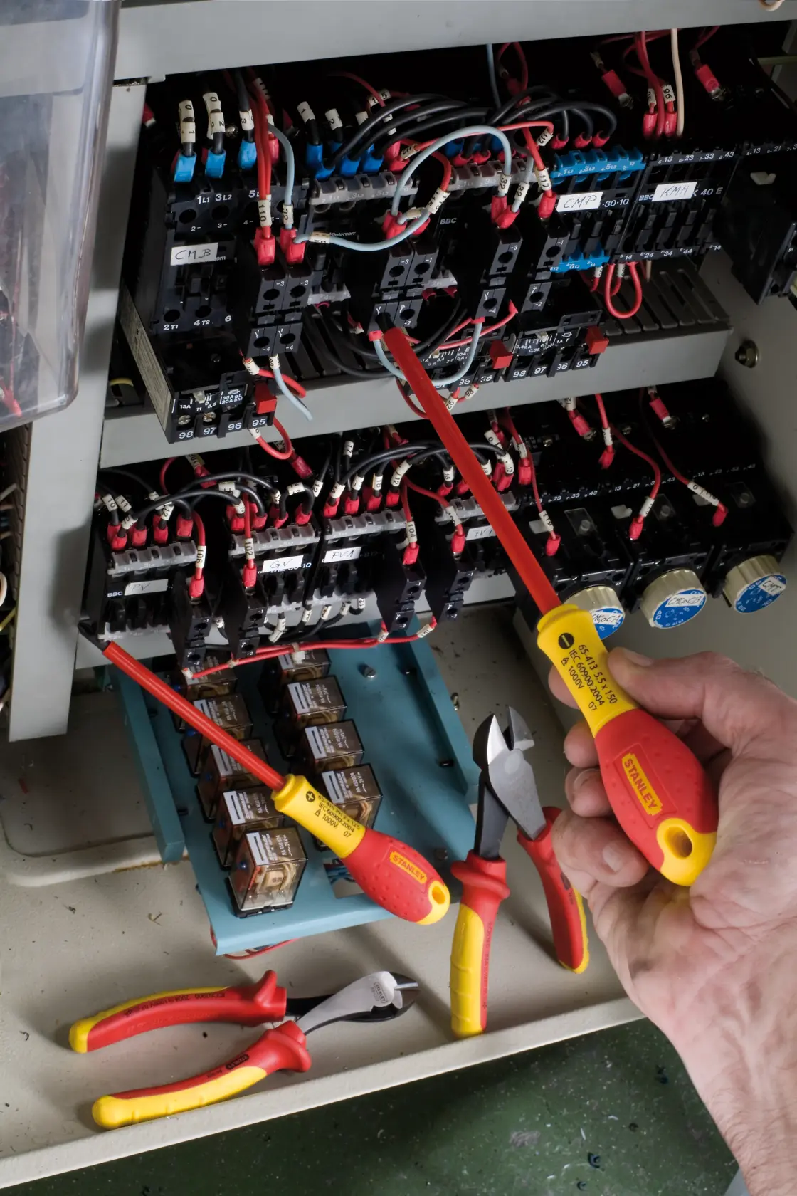STANLEY 0-65-413 insulated screwdriver, yellow and red handle, used on electrical control panel.