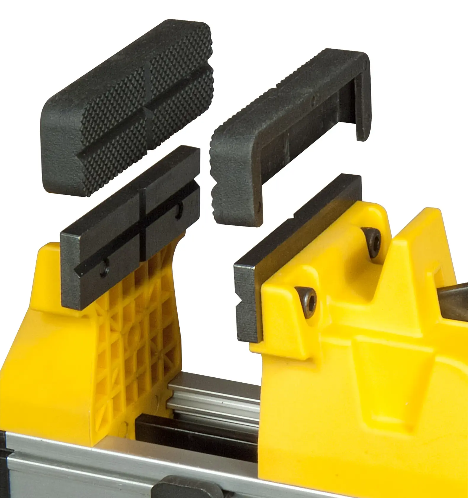 Close-up of a yellow Stanley vise with detachable black textured jaw inserts shown above.