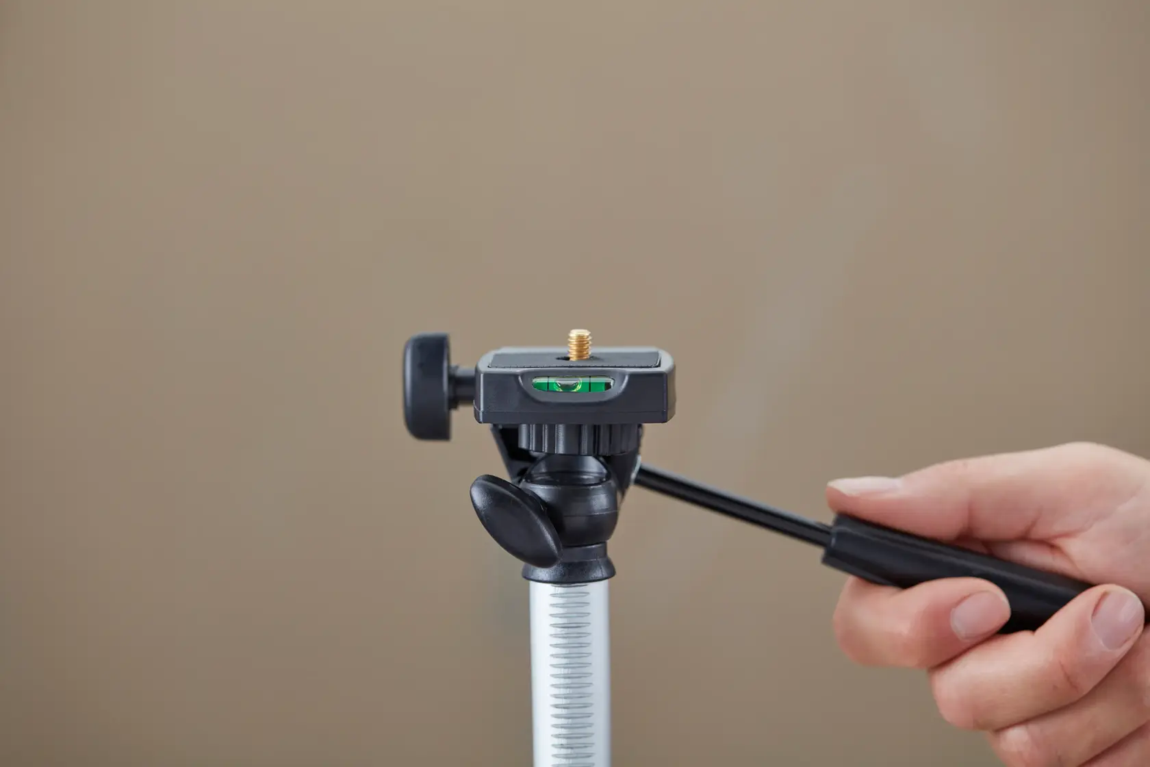 STANLEY 1-77-201 photography tripod head, close-up view, hand adjusting handle.
