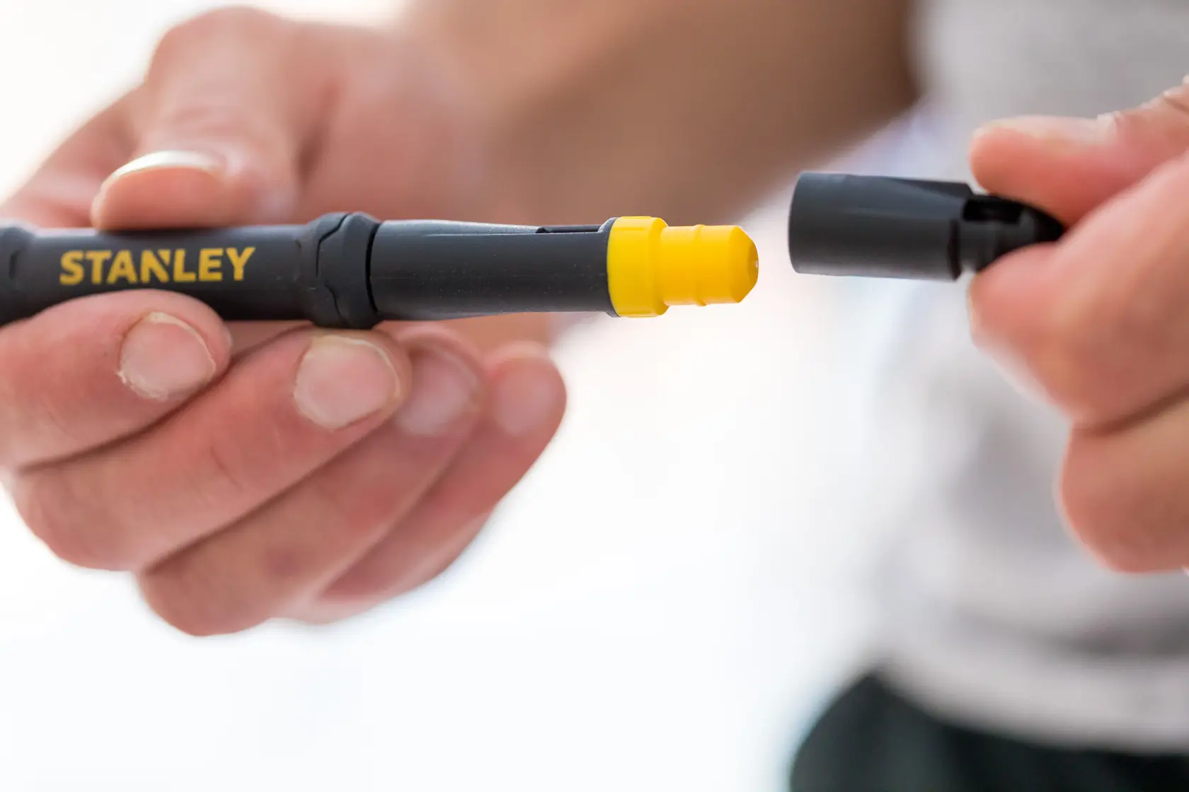 STANLEY 66-344M screwdriver with yellow interchangeable tip held in hand, close-up photography.