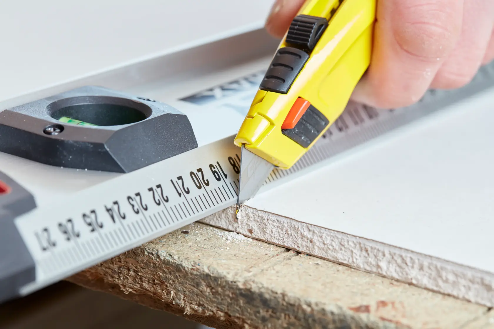 STANLEY 8-11-800 utility knife cutting along ruler, close-up angle, product photography.