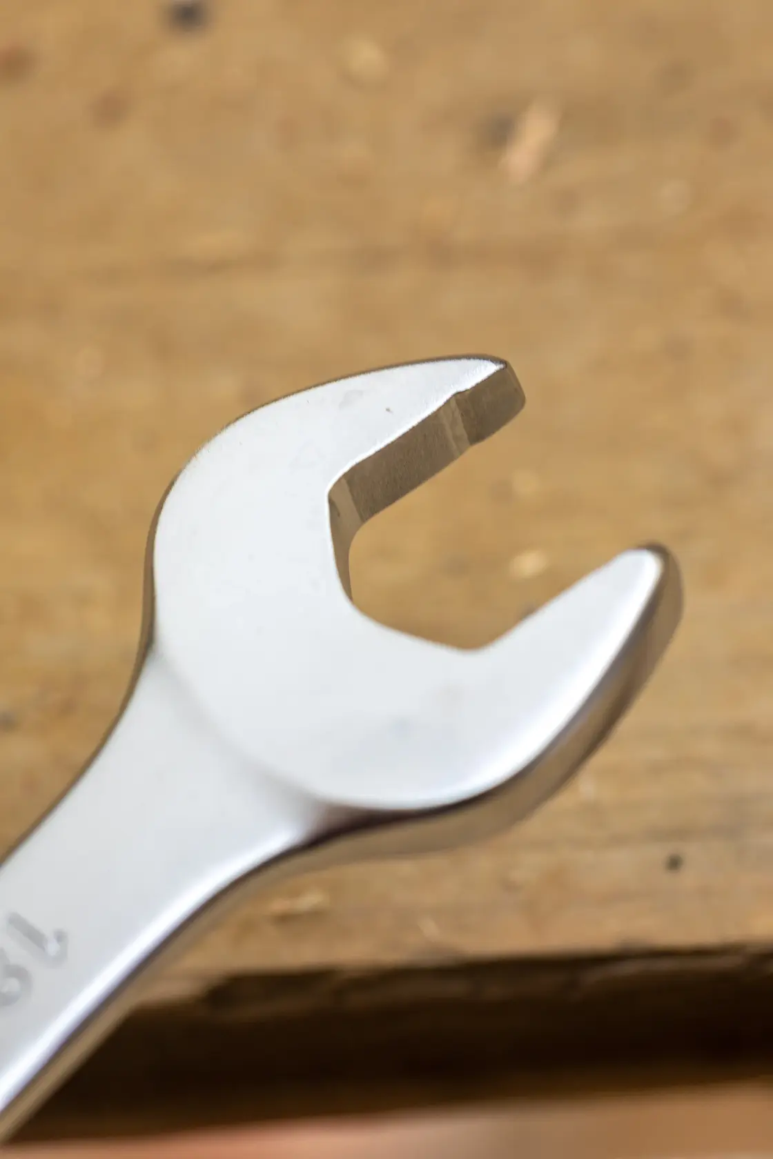 STANLEY FMMT13034-0 open-end wrench close-up on a wooden surface, silver finish, hand tool.