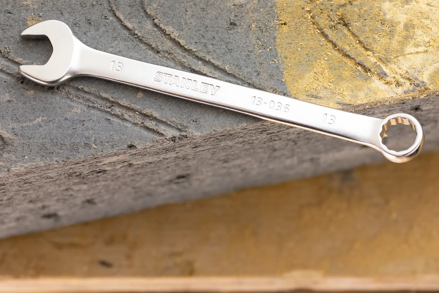 STANLEY FMMT13035-0 combination wrench in silver, photography of tool placed on stone surface.