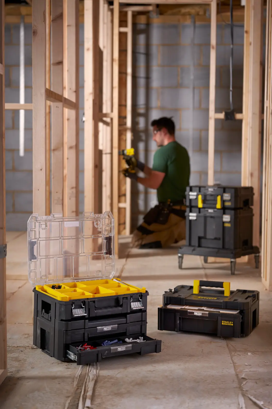 STANLEY FMST1-71969 modular toolboxes with yellow accents in a construction site photography.