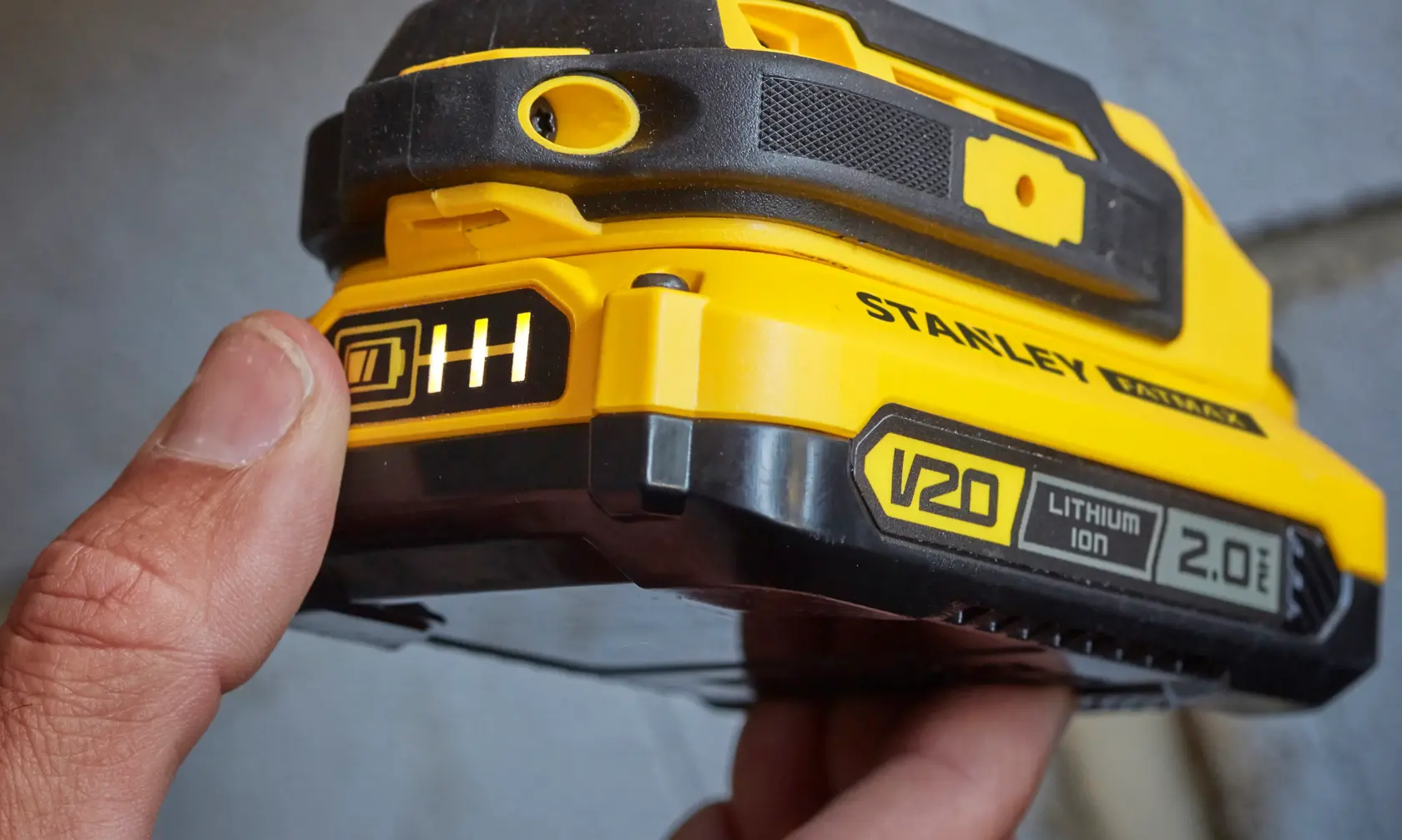 Photo of STANLEY SFMCD711D11 V20 Lithium Ion 2.0Ah battery pack close-up, showing charge indicator.