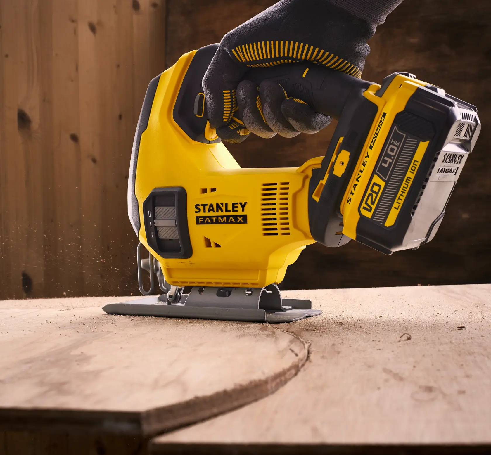 STANLEY SFMCS600M1K jigsaw, yellow cordless tool cutting wood, close-up, FATMAX branding visible.