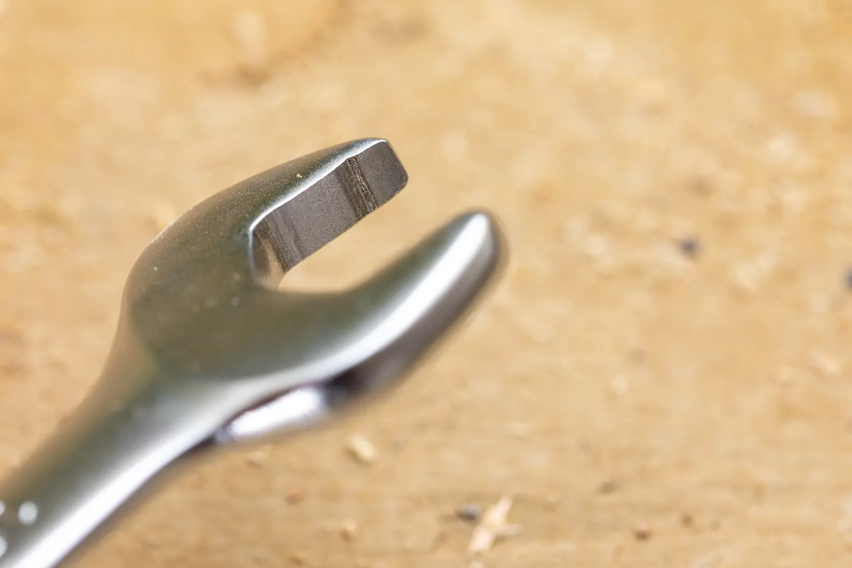 STANLEY STMT82846-0 wrench photo, close-up view of open-end jaw with metallic finish on wooden surface.