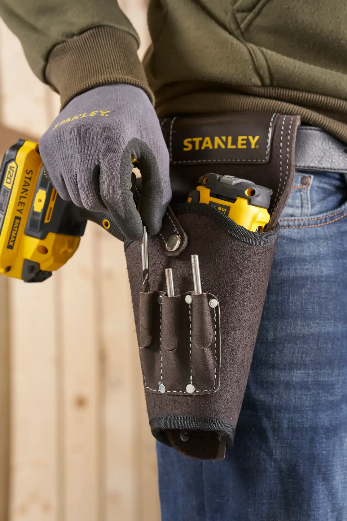 Photo of STANLEY STST1-80118 leather tool holster with tools, attached to a belt at the waist.