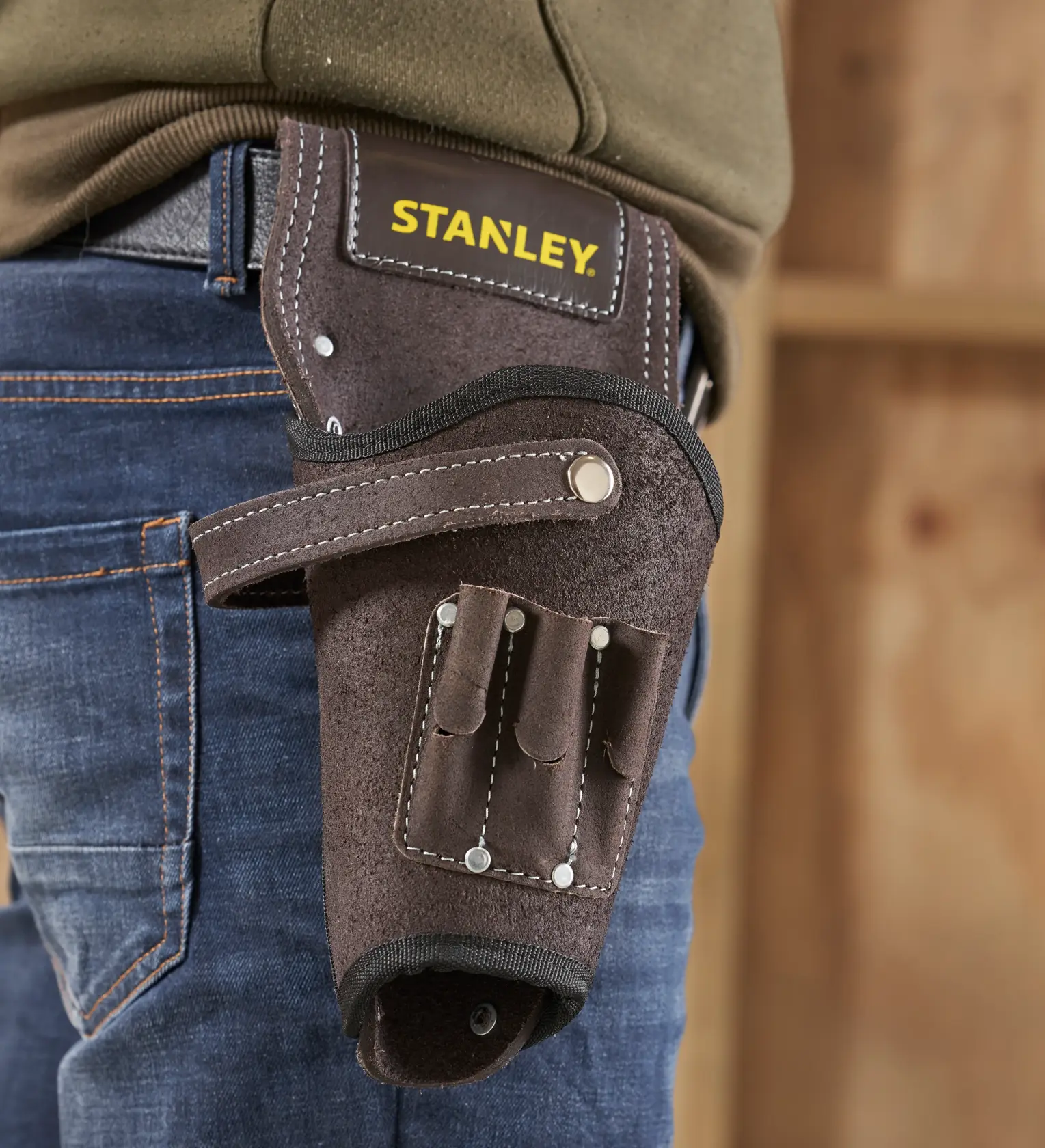 STANLEY STST1-80118 leather tool holster on belt, brown with multiple tool slots, close-up side view.